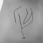 simple woman back line art tattoo