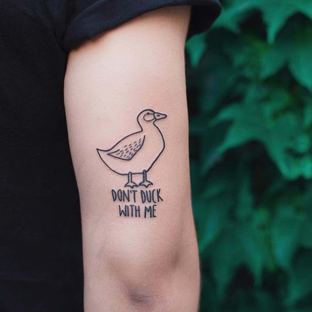 funny duck tattoo with quote on arm