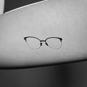 small cat eye glasses tattoo minimal design