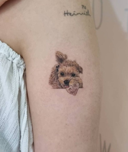 detail dog tattoo on arm